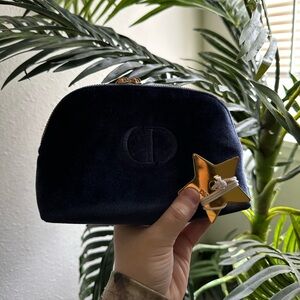 Christian Dior blue makeup bag and Dior Star bag charm